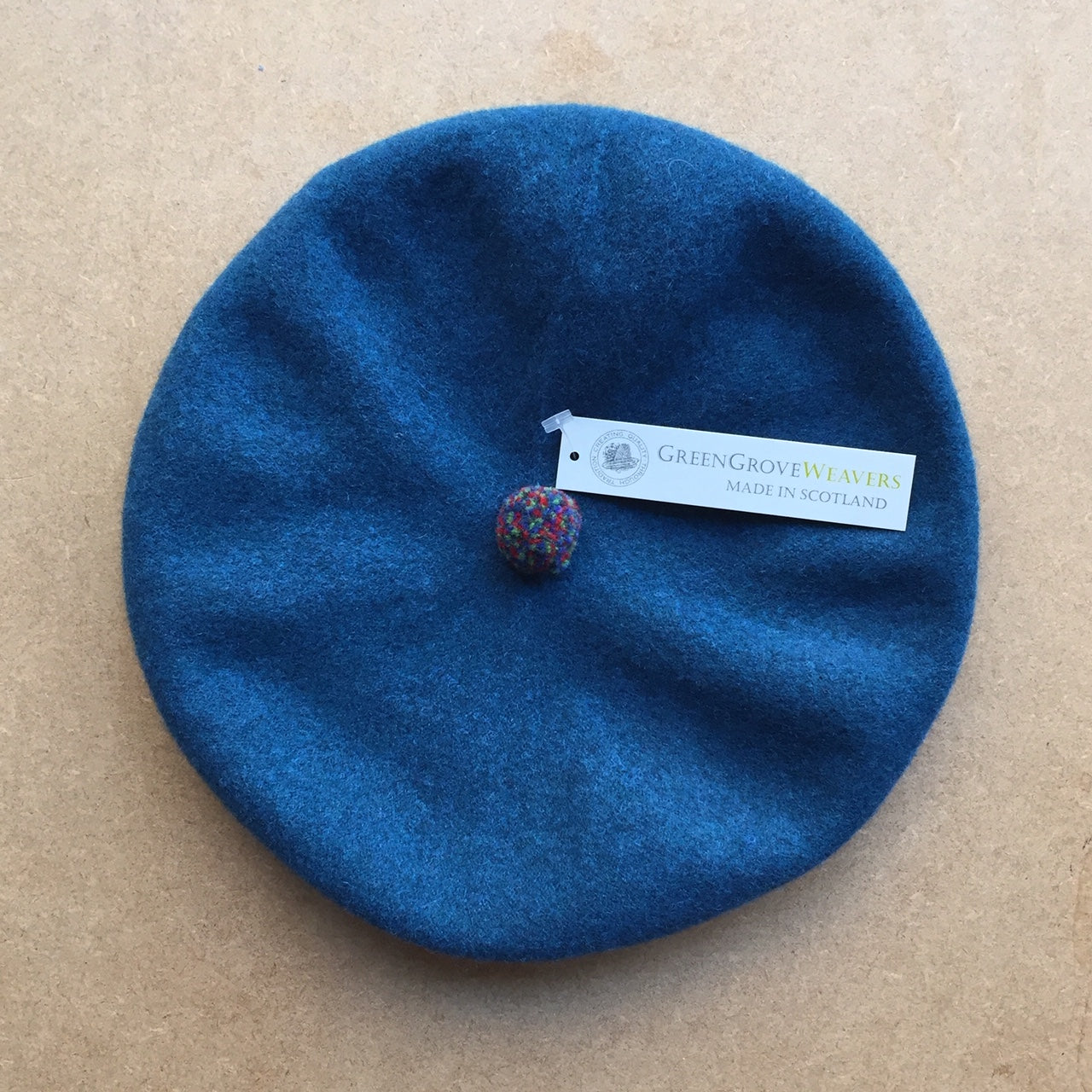 Green Grove Weavers Pom Pom Beret hat -peacock-